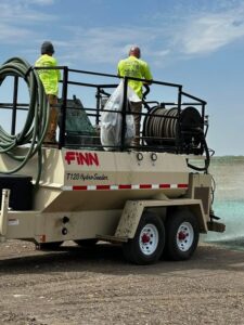 Two men on a FINN-T120 Hydroseeder.